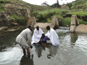 catechumen being baptised at a river near St Barnabas Orthodox Mission Kenya
